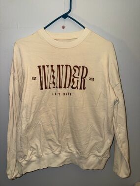 Lux Cream Crewneck Sweatshirt with Brown 'WANDER' Graphic